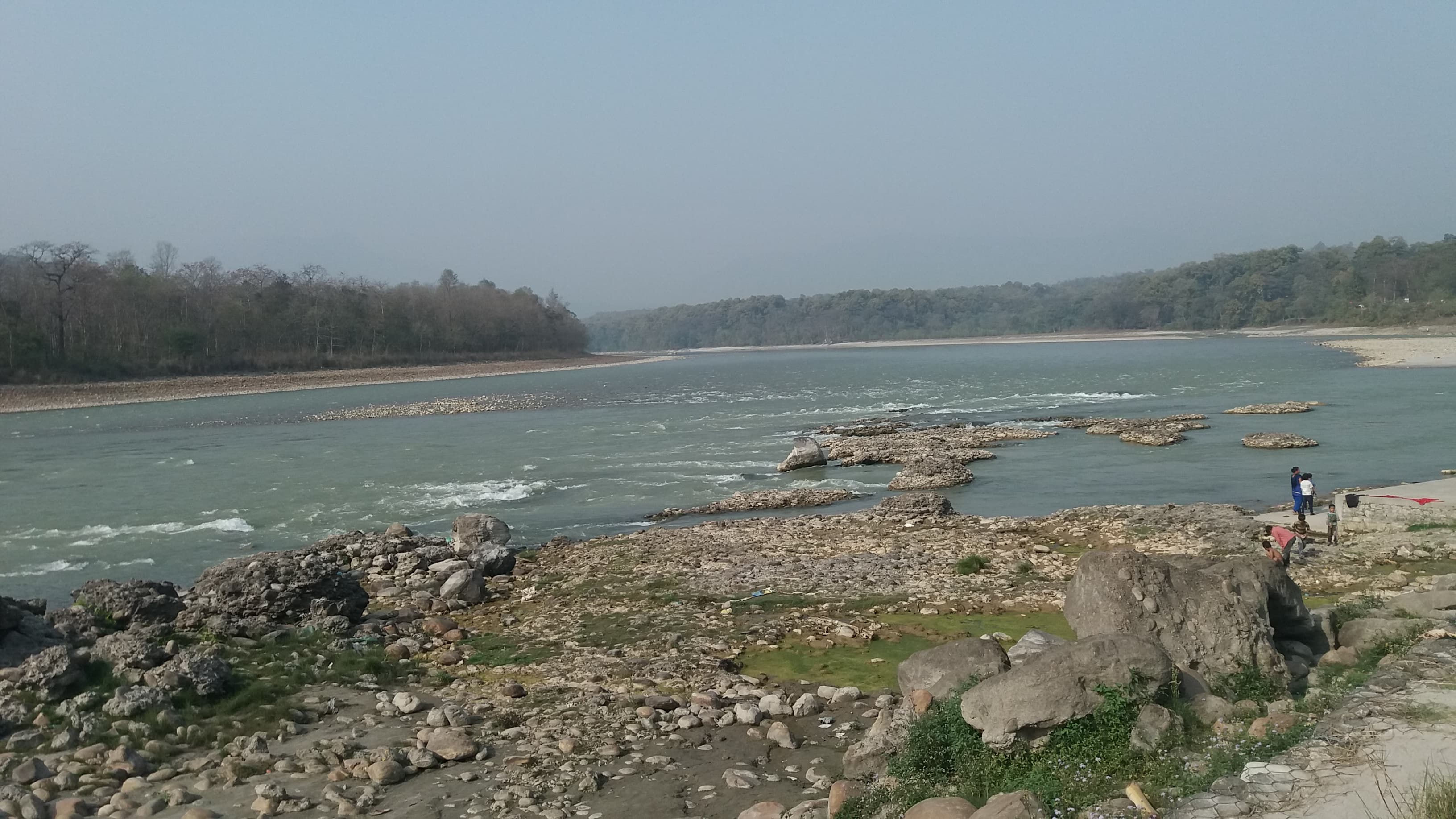 A wide river bordering the forests of the western Terai